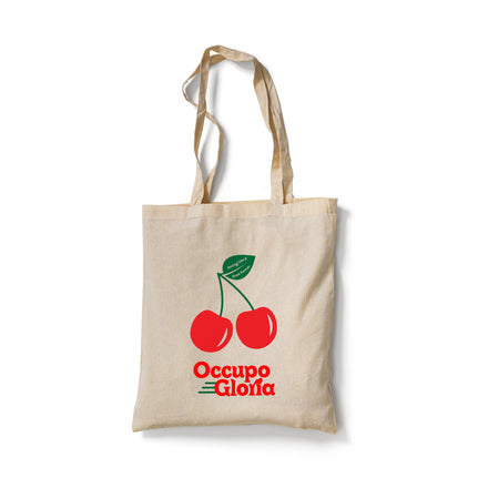A high-quality canvas tote bag featuring the vibrant vintage cherry design. The bold print showcases a designer cherry logo with green leaves and branding, adding a retro, vintage vibe. The bag is photographed against a clean backdrop, highlighting its durability and stylish simplicity.